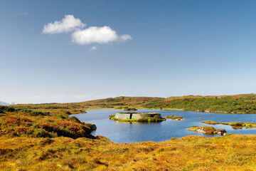 Doon Fort prehistoric stone cashel caiseal or dun. Pre Christian refuge on small crannog lake isle in Doon Lough near Ardara, Donegal, Ireland