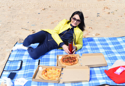 Russian 45 Year Old Woman Going To Eat Pizza While Sitting On The Beach