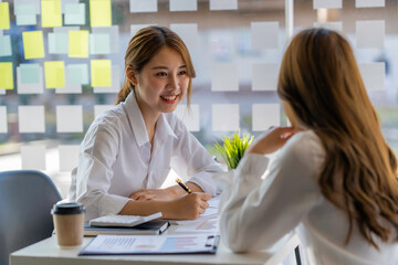 two successful business women working together in the office