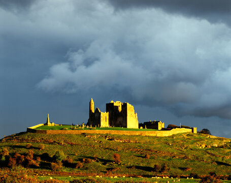 Mediaeval cathedral, round tower and Cormac’s Chapel sit on the Rock of Cashel, County Tipperary, Ireland. Sunset after rain