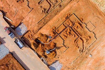 Aerial view of a bulldozer work at new construction installation on water drainage system in new foundation