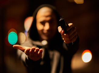 Your goods or your life. Shot of a gun-wielding thief aiming his weapon.