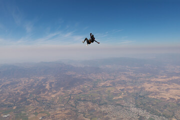 Freefly skydiving. Solo skydiver is having fun in the sky.