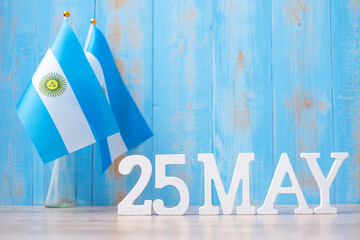 Wooden text of May 25th with Argentina flags. Argentina Revolution day and happy celebration...