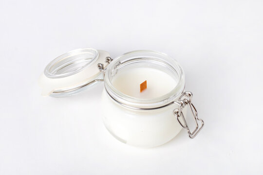 Soy candles in glass cans, handmade modern hobby , harmless coconut wax candles without paraffin with wood on white background isolated