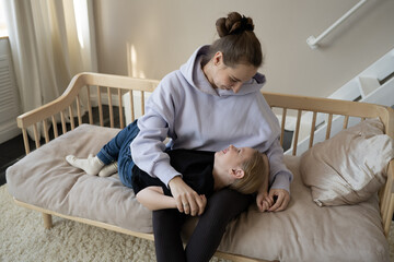 A happy family, a mother and a schoolgirl daughter hug. Mother's Day.