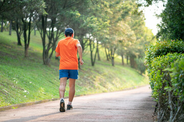 Man runner jogging in a park.