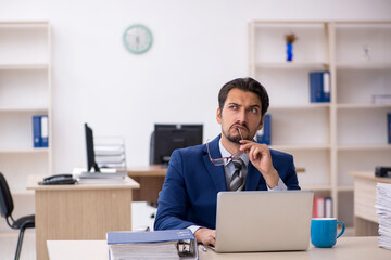 Young male employee working in the office