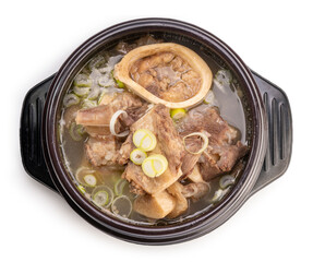 Beef bone marrow soup in hot iron pot isolated on white background, Beef Stock Bone soup or Seolleongtang in iron pot on white With clipping path.