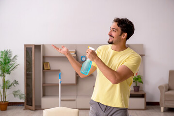 Young man doing housework at home