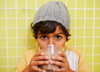 Nothing beats a chocolate milkshake. Shot of a cute little boy drinking a milkshake.