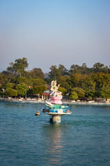 Fototapeta na wymiar hindu goddess statue in the middle of ganges river with flat sky