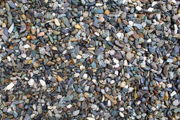 Small colorful pebbles background. Multicolored abstract beach nature stones.
