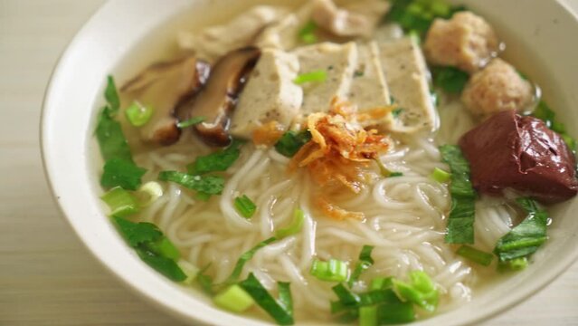 Vietnamese Rice Noodles Soup with Vietnamese Sausage served vegetables and crispy onion - Asian food style