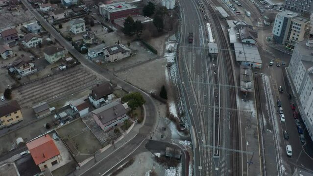 Aerial of large trainyard near city in winter