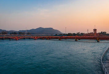 isolated iron bridge over ganges river with colorful sky at evening