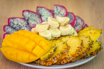 Vietnamese asia fruits: pineaple, banana, dragon fruit, mango. Fresh, jucie and very tasty.