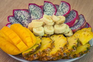 Vietnamese asia fruits: pineaple, banana, dragon fruit, mango. Fresh, jucie and very tasty.
