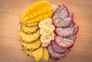 Vietnamese asia fruits: pineaple, banana, dragon fruit, mango. Fresh, jucie and very tasty.