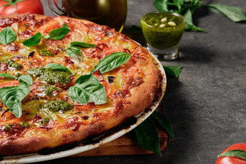 Homemade pizza. Traditional rustic Italian pizza with green basil pesto, close-up, selective focus. Pizza delivery, menu idea