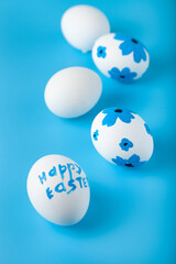 Easter card design. Easter eggs decorated flowers on blue background.