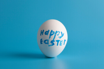 White egg  with text on a blue background.
