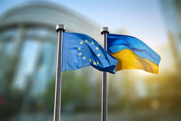 Flags of Ukraine and European Union against EU parliament - obrazy, fototapety, plakaty