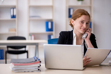 Young female employee working in the office