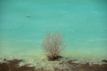 Turquoise waste waters from a copper mine polluting  the environment. Geamana decantation lake,...