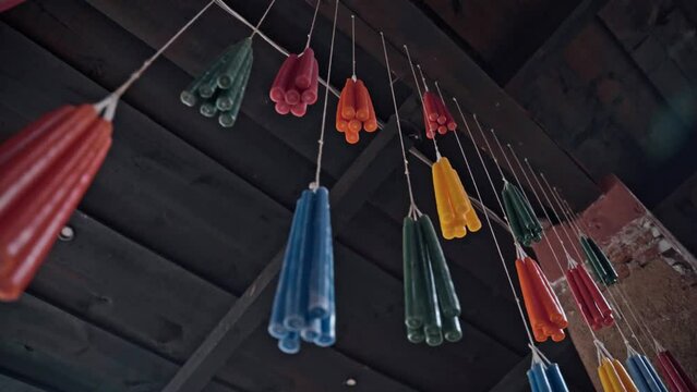 Colorful candles hanging on string in Guatemala. Traditional symbol. Handheld motion view