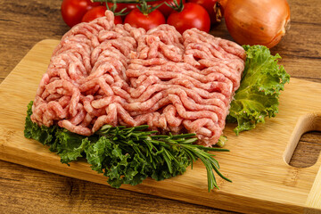 Raw pork minced meat over board