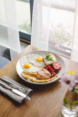 morning in a beautiful cafe for breakfast fried egg with tomato and chicken 