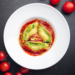 pasta stuffed cheese spinach tomato sauce shell stuffing conchiglie garnish healthy meal food snack on the table copy space food background 