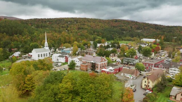 Cinematic aerial of white wooden old historic building of church in Stowe town
