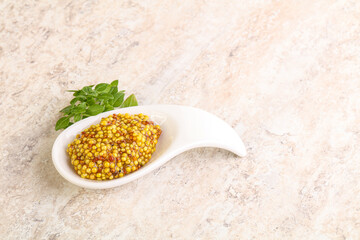 Grain mustard sauce in the bowl