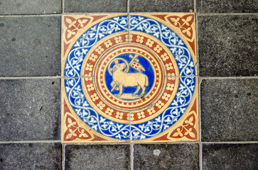 Victorian tile showing lamb and flag