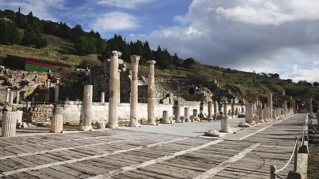 Ruins of the Upper Agora at Ephesus ancient site in Turkey. View of fragments of columns, with the Sacred Street and Odeon 