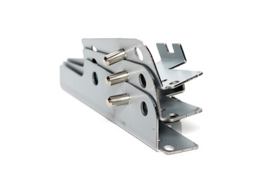 Stack of three metal brackets with stud pins on white background, selective focus.