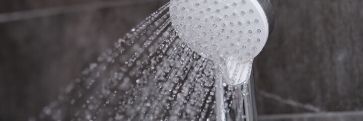 Splashing water from the mixer in the bathroom for a shower