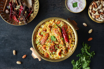 Chicken biryani Spicy Indian Malabar biryani Hyderabadi biryani, Dum Biriyani pulao golden bowl Kerala India Sri Lanka Pakistan basmati rice mixed rice dish with meat curry Ramadan Kareem, Eid