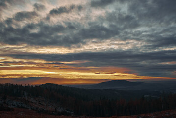 Sunset with dramatic cloudy sky over mountains shape, beautiful nature landscape