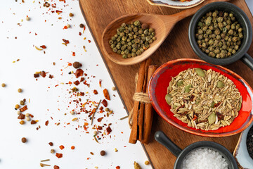 Bowls with various spices on white background