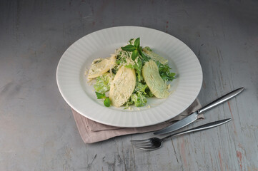 georgian green salad with nadugi on gray background