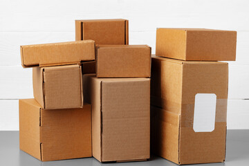 Group of cardboard boxes against white wooden wall