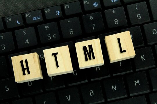 laptop keyboards and wooden cubes with HTML letters