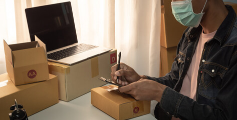 Small business owner packing in the card box at workplace. Cropped shot of man preparing a parcel for delivery at online selling business office. Ecommerce drop shipping shipment service concept.