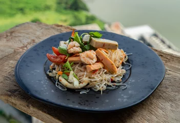 Deurstickers Seafood spicy glass noodle salad or Spicy delicious Mung bean Noodle Salad with fresh seafood (Yum woon sen) on wooden table. Spicy vermicelli salad, Vegetables and herbs, Sour & spicy, Thai cuisine,  © num