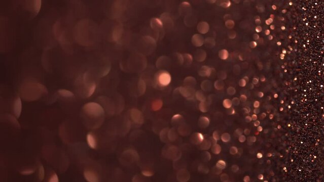 Eid holiday lights. Abstract copper glitter background with moving and flicker particles. Magic dust, metallic sequins, shiny texture, flying particles form a beautiful bokeh. Shining backdrop