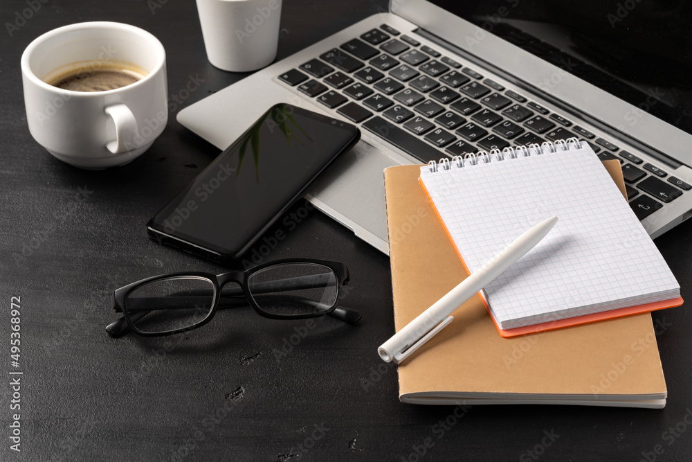 Canvas Prints Notepad is on top of office desk table with laptop and supplies