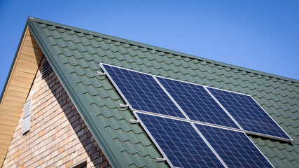 Solar panels on a green metal roof. Environmentally and energy saving